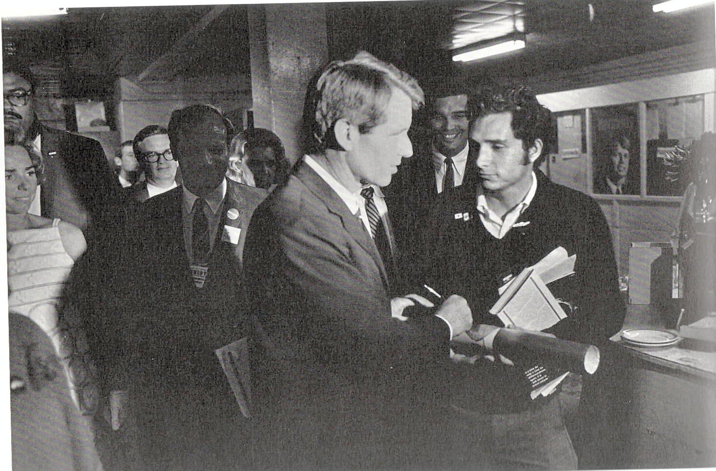 People's Exhibit 33; F3906:190; Trial; photo: RFK signing autograph for Michael Wayne